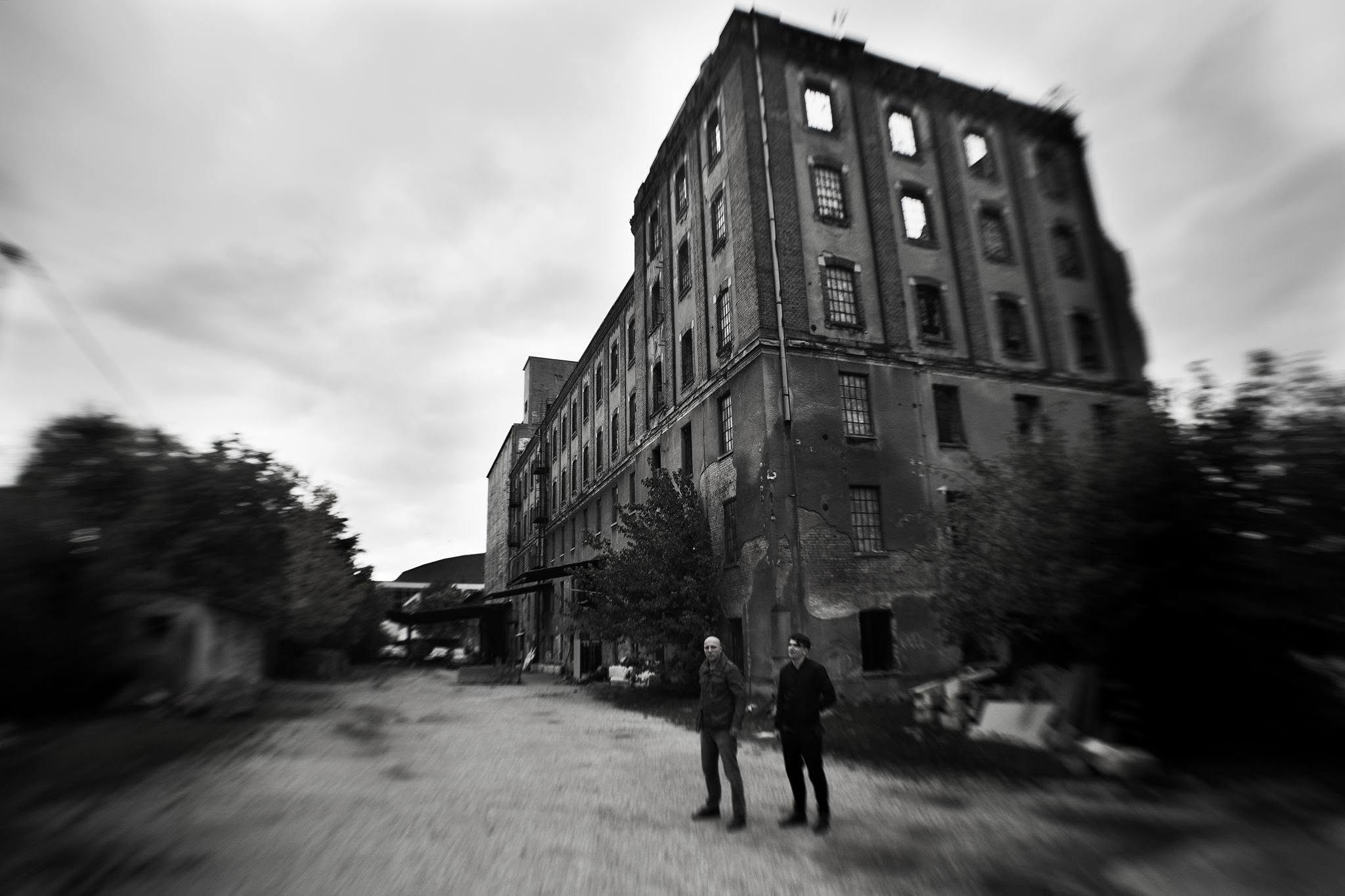 Vio and Dacian in front of a derelict brick factory, black and white